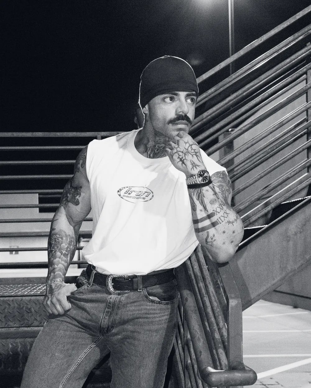 Athlete in the sleeveless tee on a stairwell at night